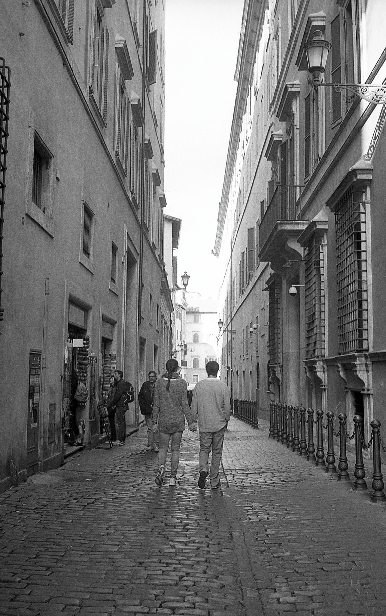 Street in Rome and two people walking side by side