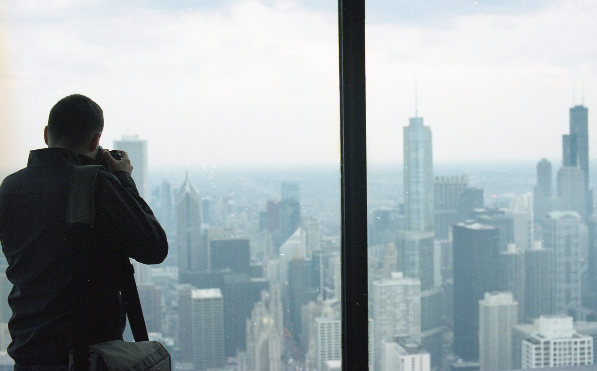 A man taking a picture out of a skyscraper in Chicago